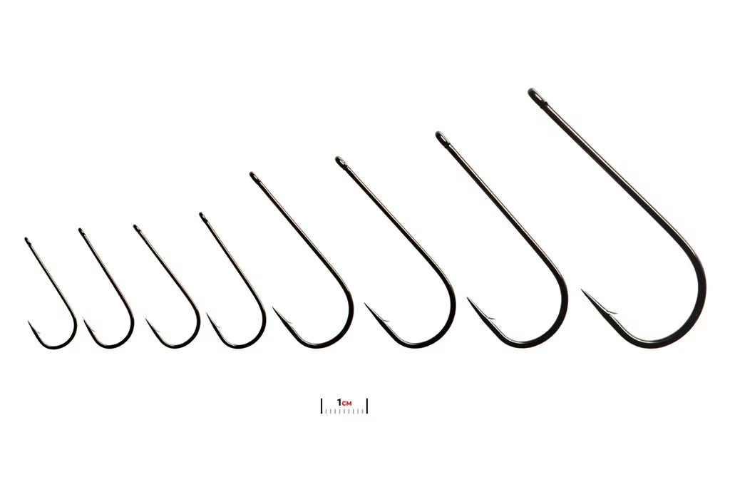 Fulling Mill 6060 Predator Hook Black Nickel Barbed, size range comparison with 1 cm scale
